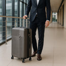 TraveLux Pro közepes bőrönd keményfedeles 42x65x24 cm sötét szürke